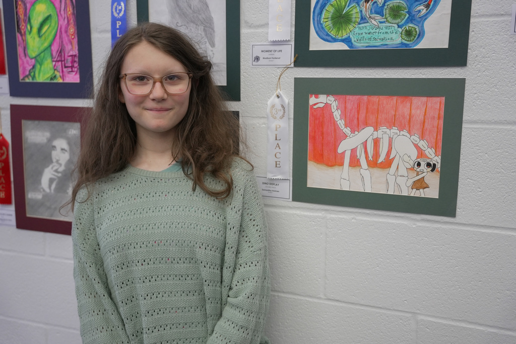 students presenting artwork at WOSMS art show