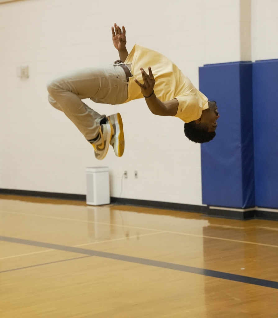 teacher doing a backflip at WOSE kickball game