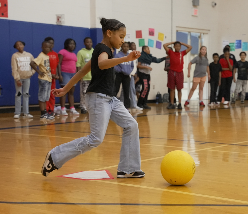 girl kicking ball at WOSE kickball game