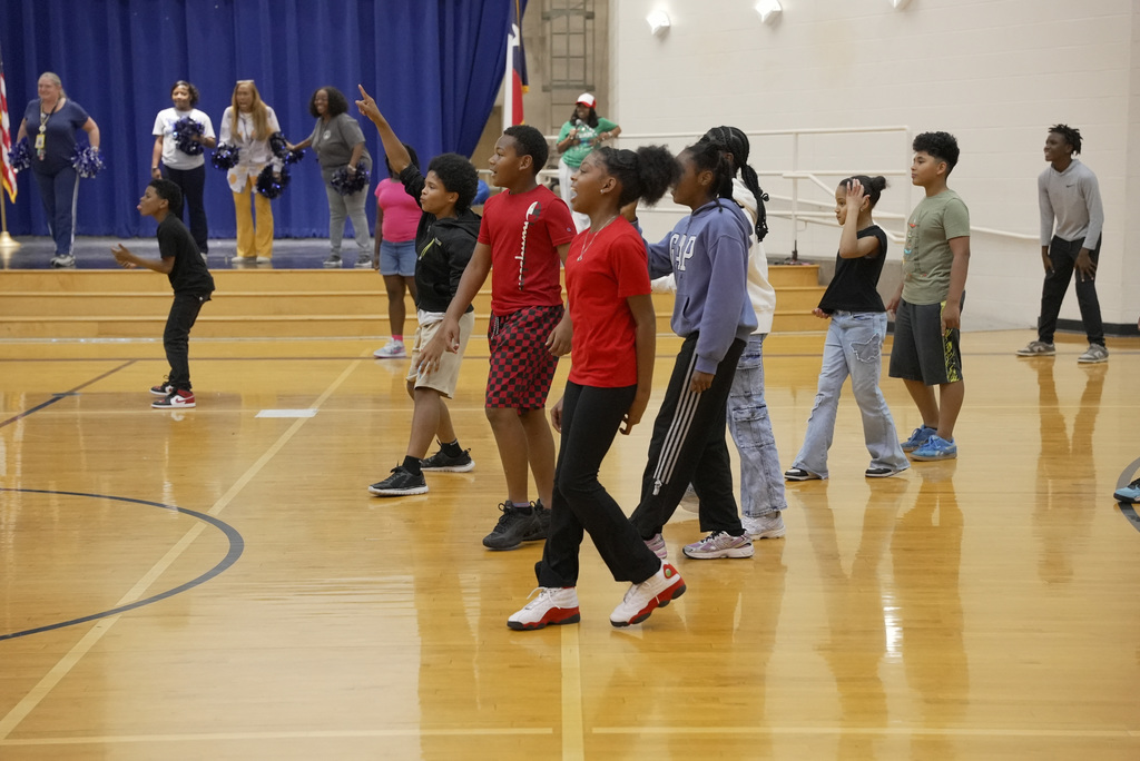 students pointing at WOSE kickball game