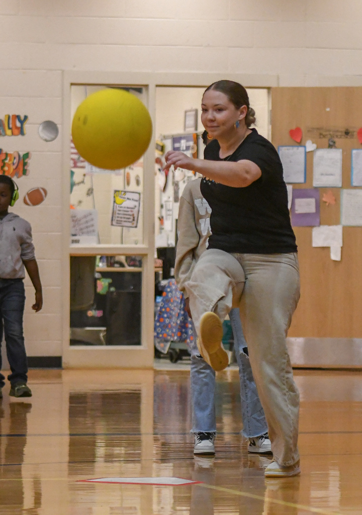 teacher kicking ball  at WOSE kickball game