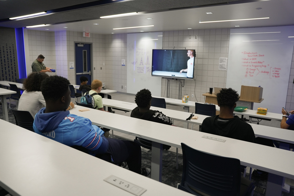 Students watching a video on how to make a tower model