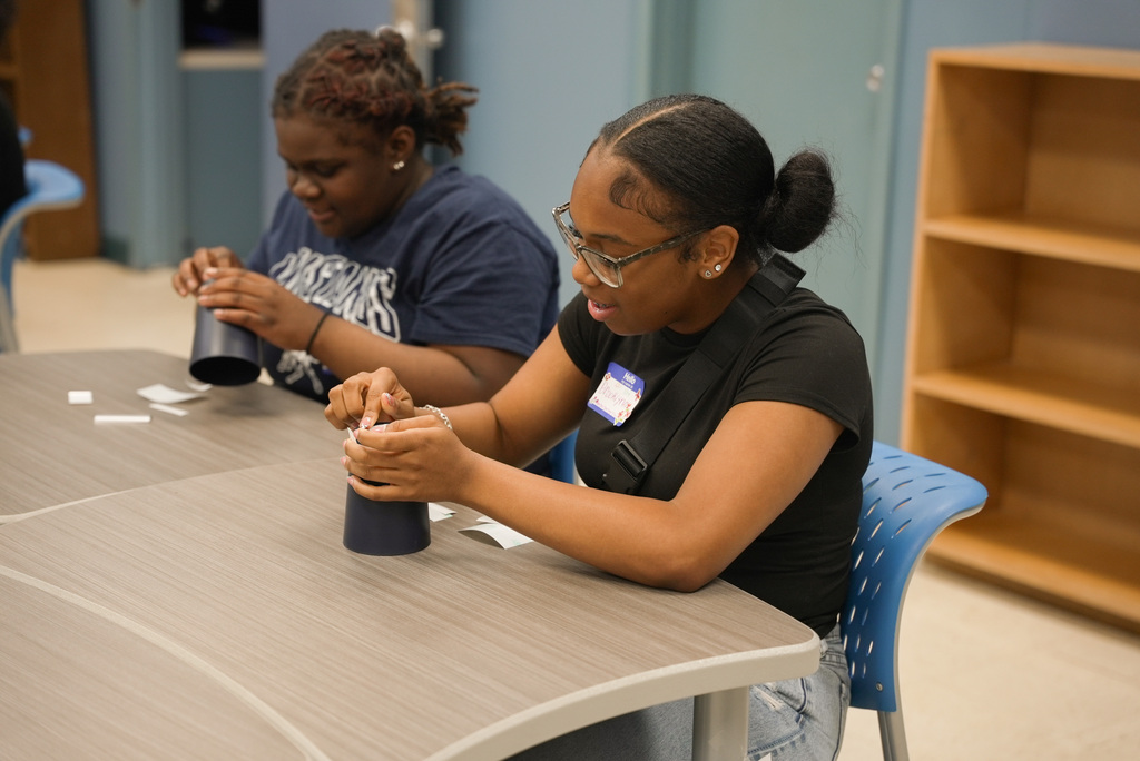 Student prepping cup for custimization