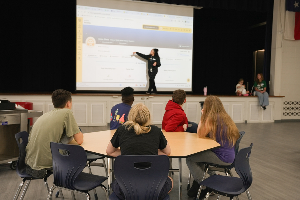 Students watching the presentation the counselor is giving