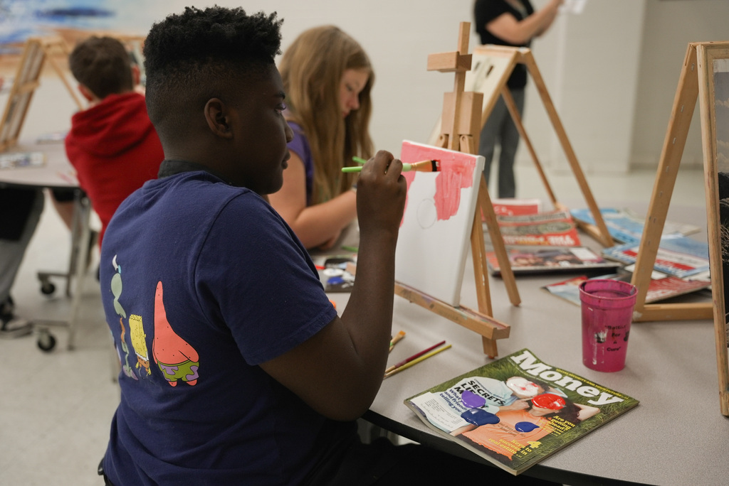 Student getting started on painting a landscape