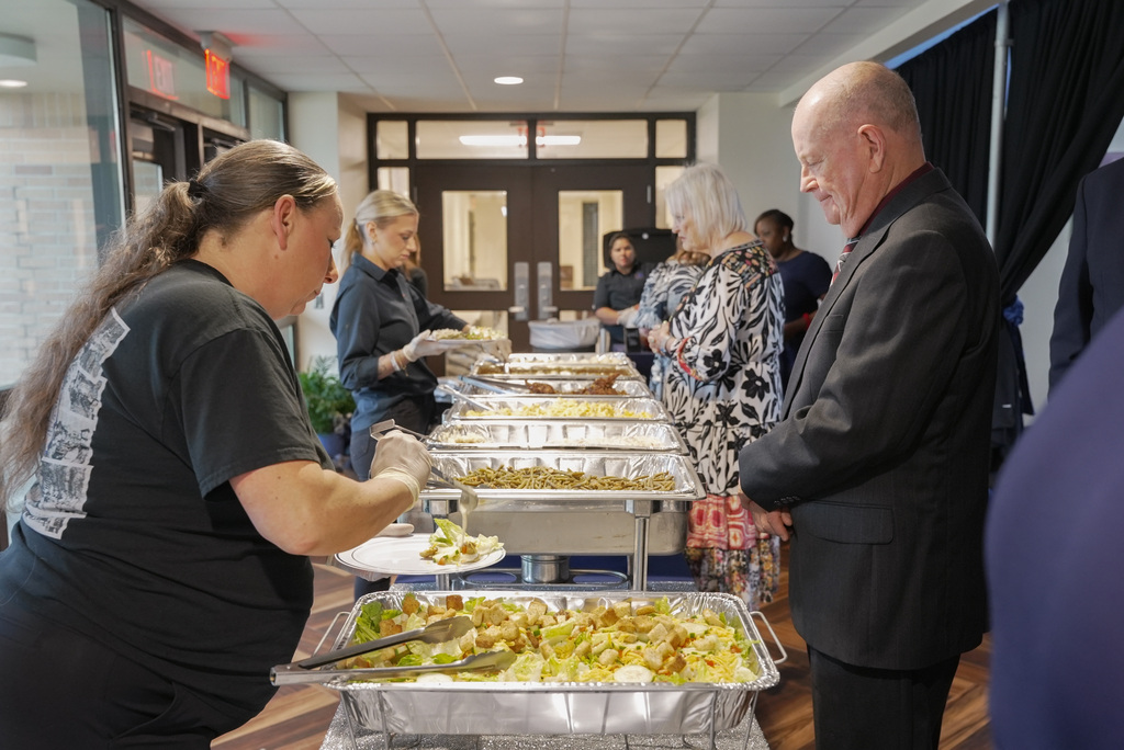 Wide spread of food being served to attendees.