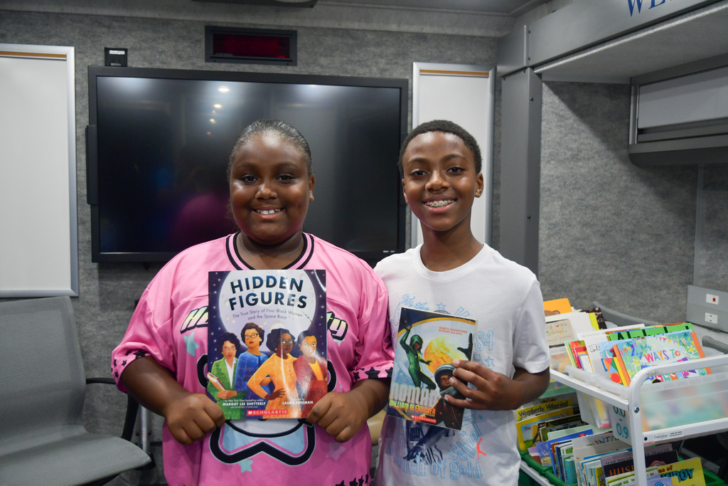 Students holding their new books