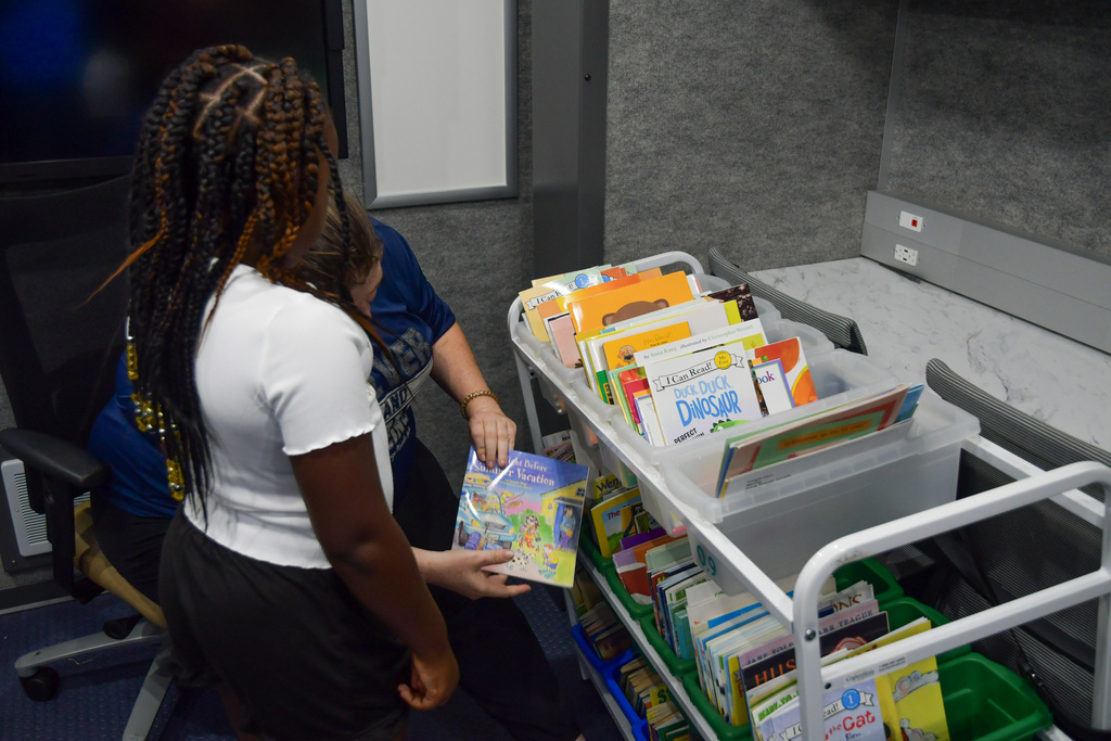 Teacher showing student a book