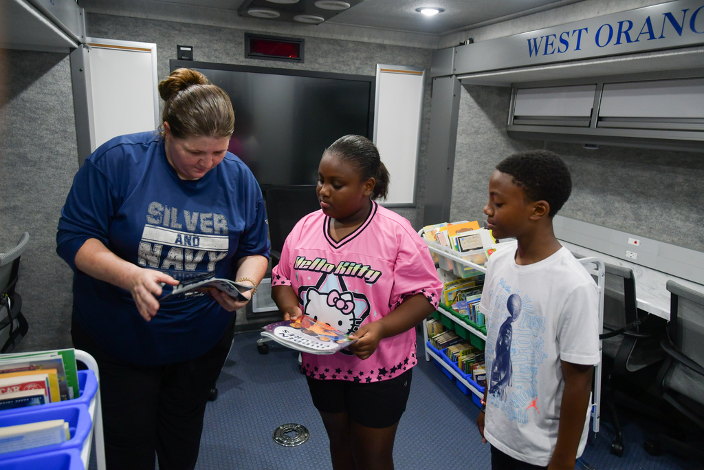 Teacher showing students a book