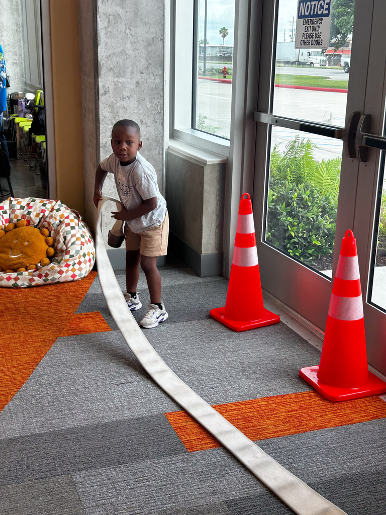 Student playing with a firehose display