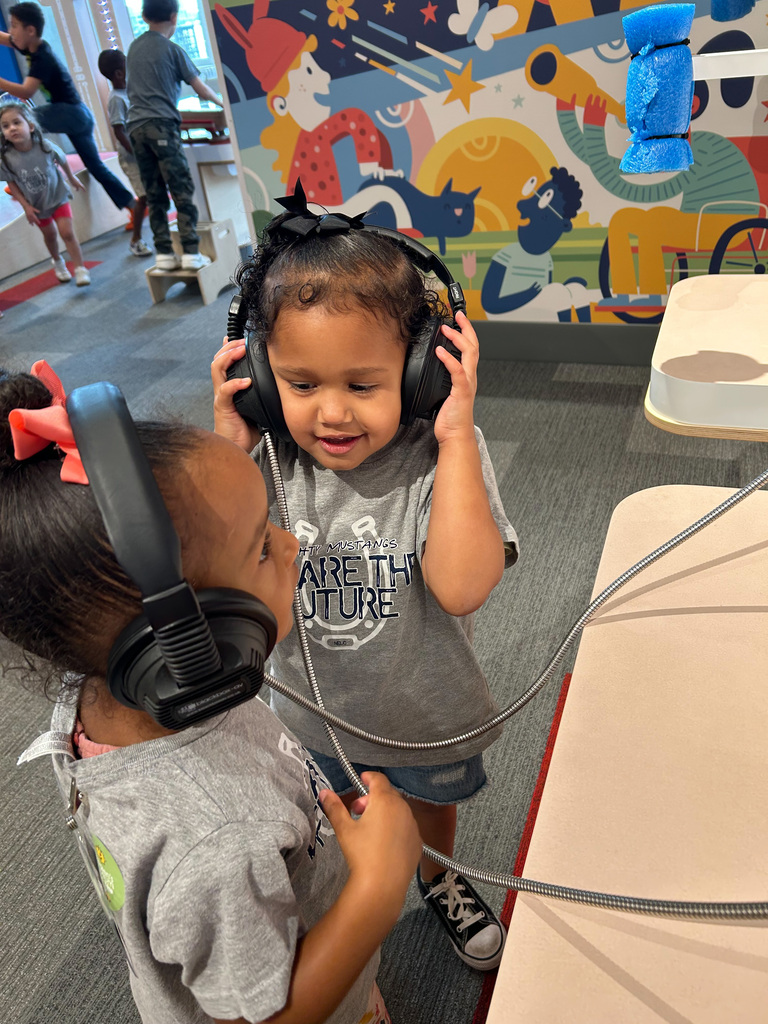 Students from NELC listening to headphones