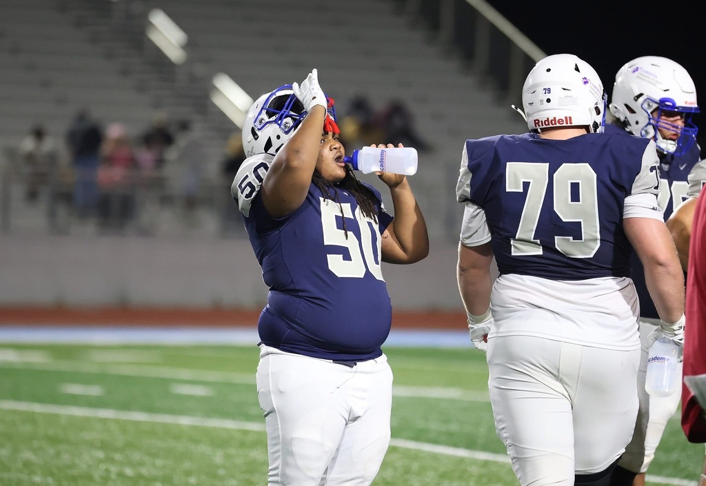 WOS player drinking water at a football game