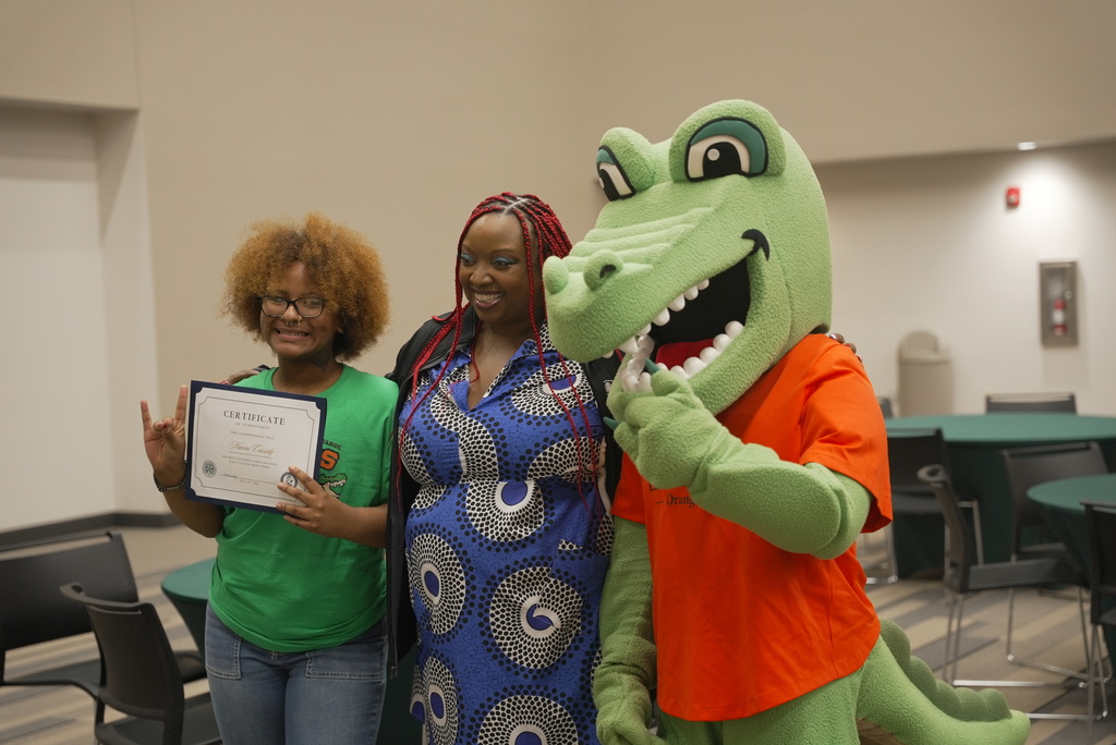 Student taking picture with Early College certificate