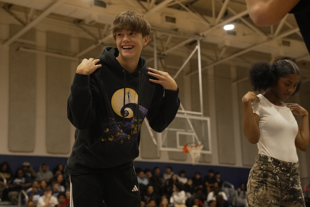 studeny playing a pep rally game, with hands touching shoulders