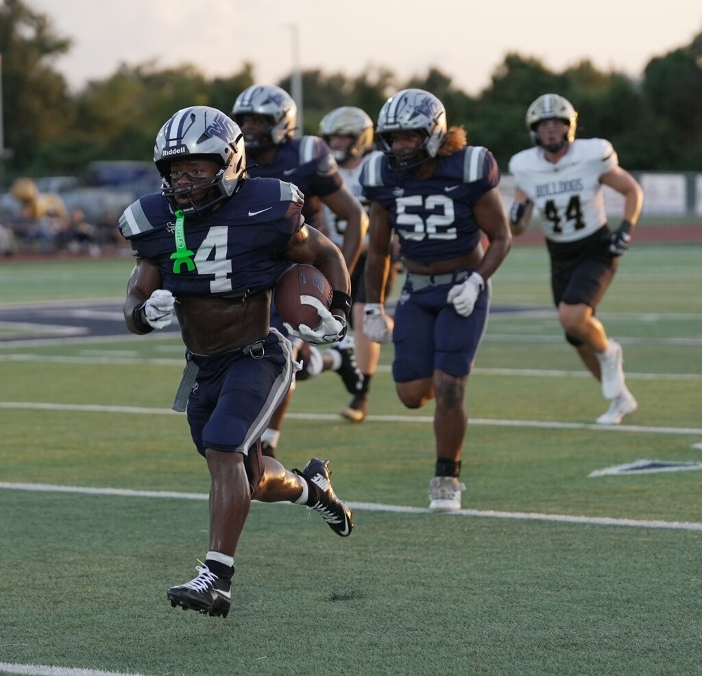 #4 Running the ball down a clear field backed by other players