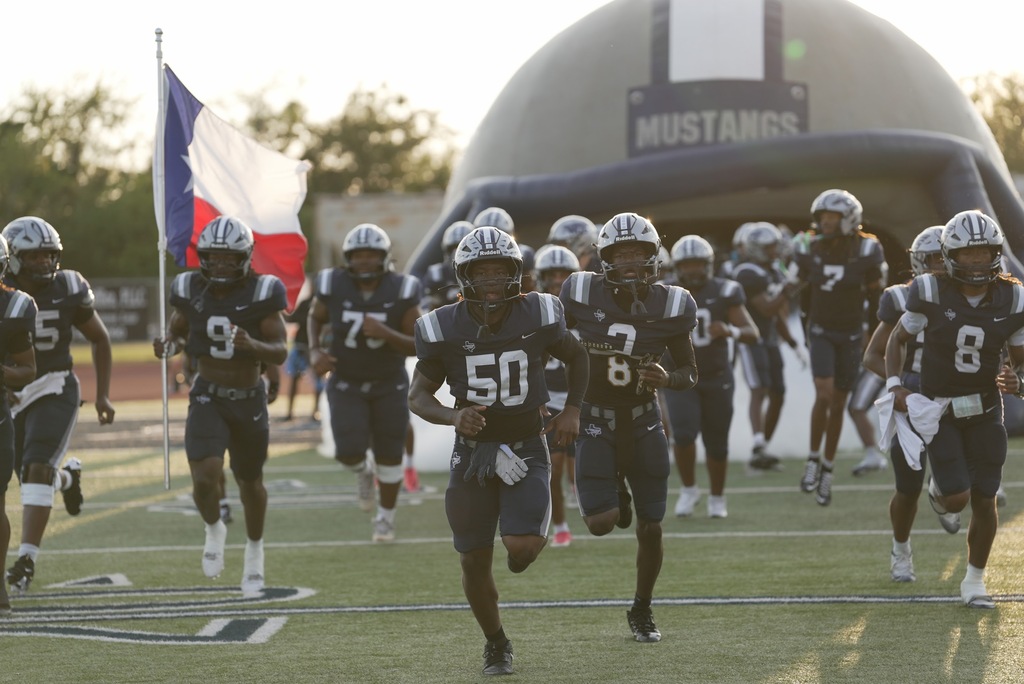 WOS Mustangs running onto the field