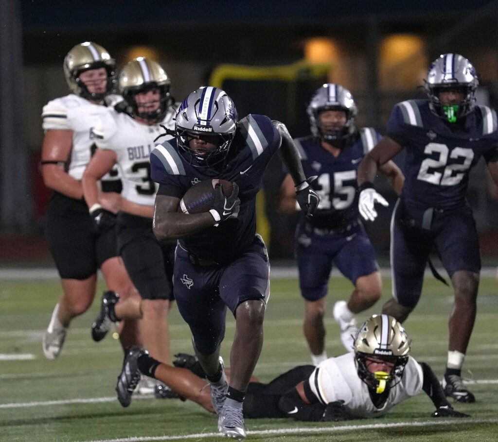 Player running the ball after dodging a tackle
