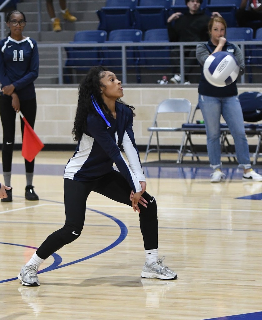 volleyball player prepping to hit ball