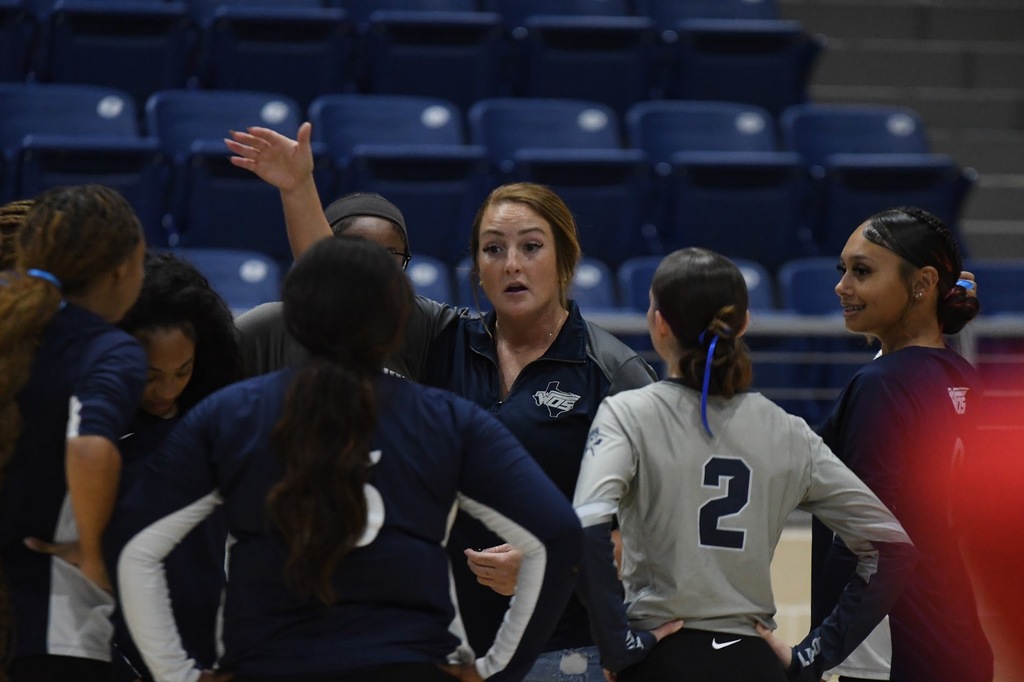 WOS Volleyball coach talking to team during a timeout
