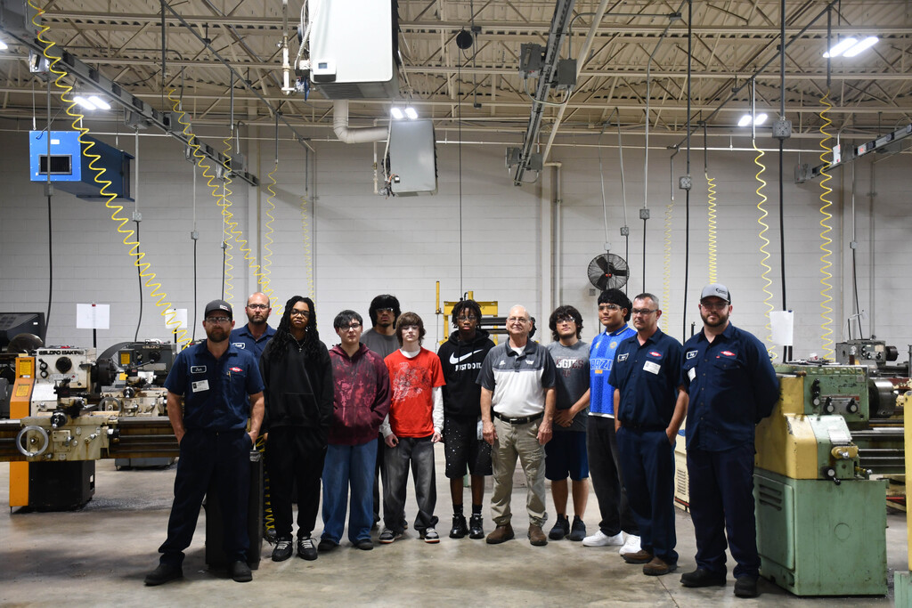 Group of students and instructors in machine shop