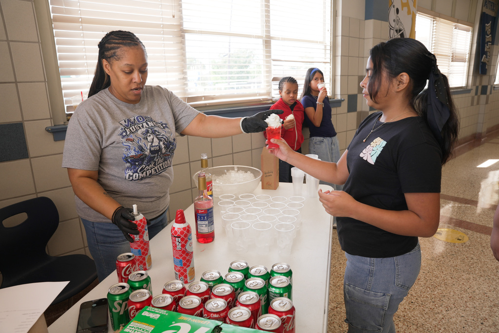 Mrs . Myers handing out a dirty soda to a student