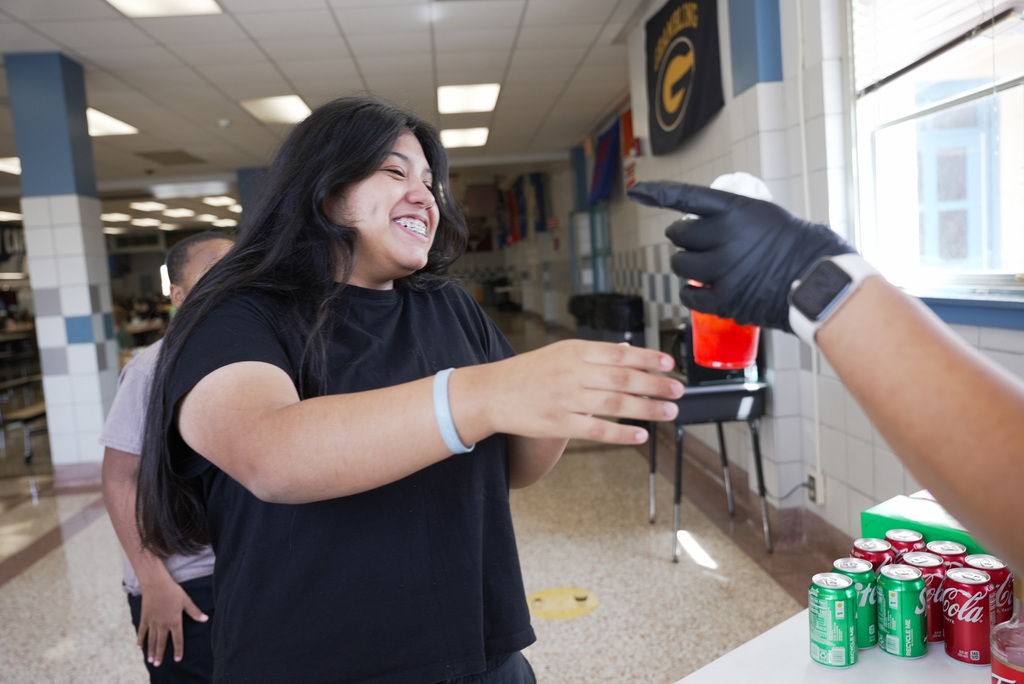 Mrs . Myers handing out a dirty soda to a student