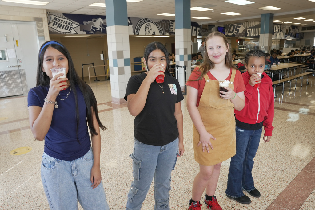 4 girls standing in a line enjoying their perfect attendance dirty soda