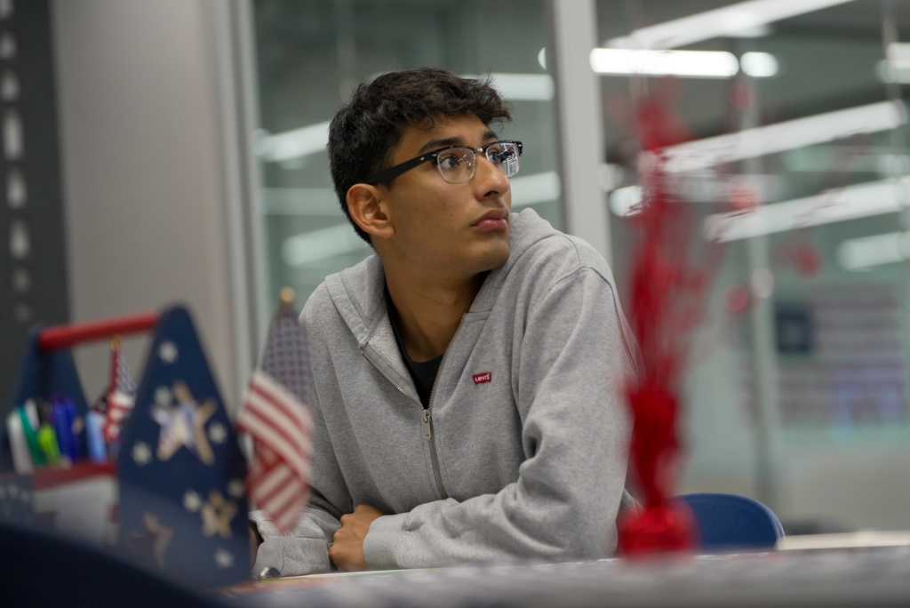 student looking away from table while registering to vote