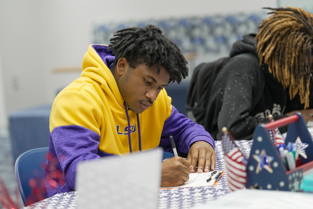 two students filling out voter registration form
