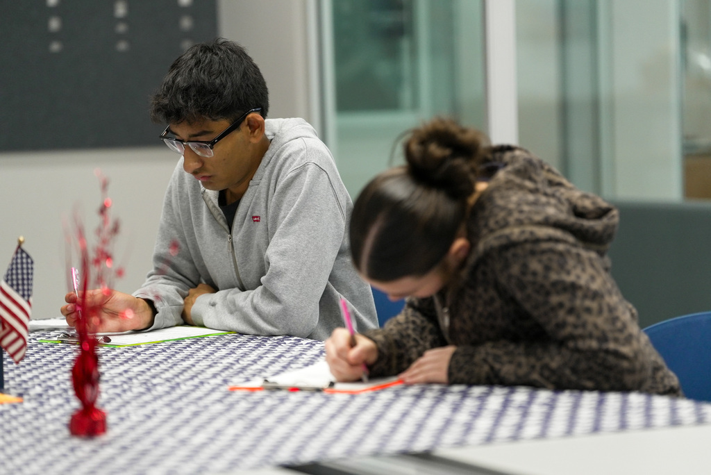 two students filling out voter registration form