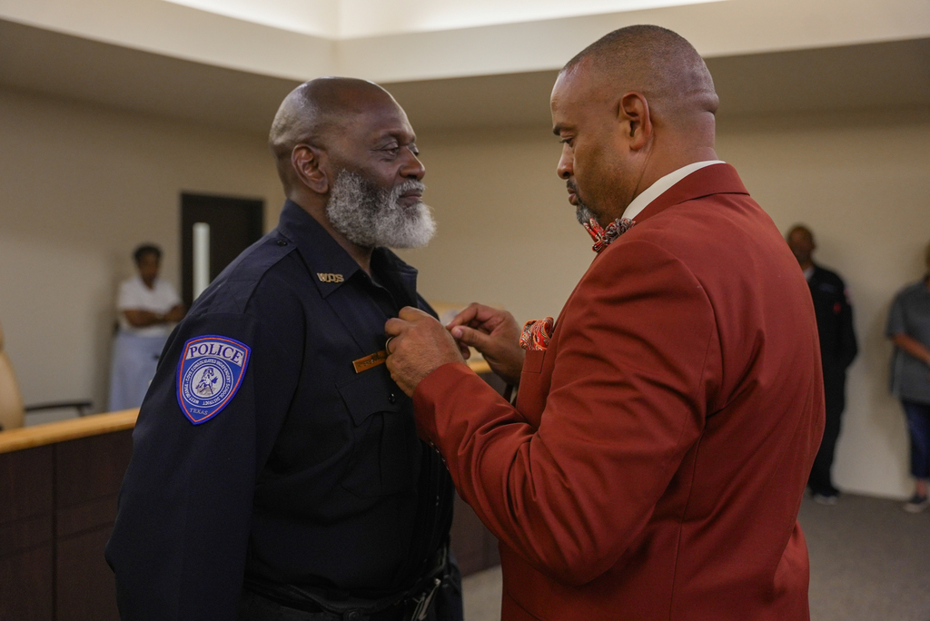 Chief of Police Shanter Norman presents Officer Breakfield with badge
