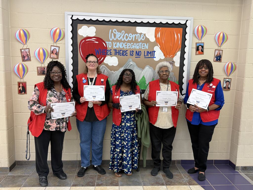 WOSE volunteer grandparents wearing their red vests