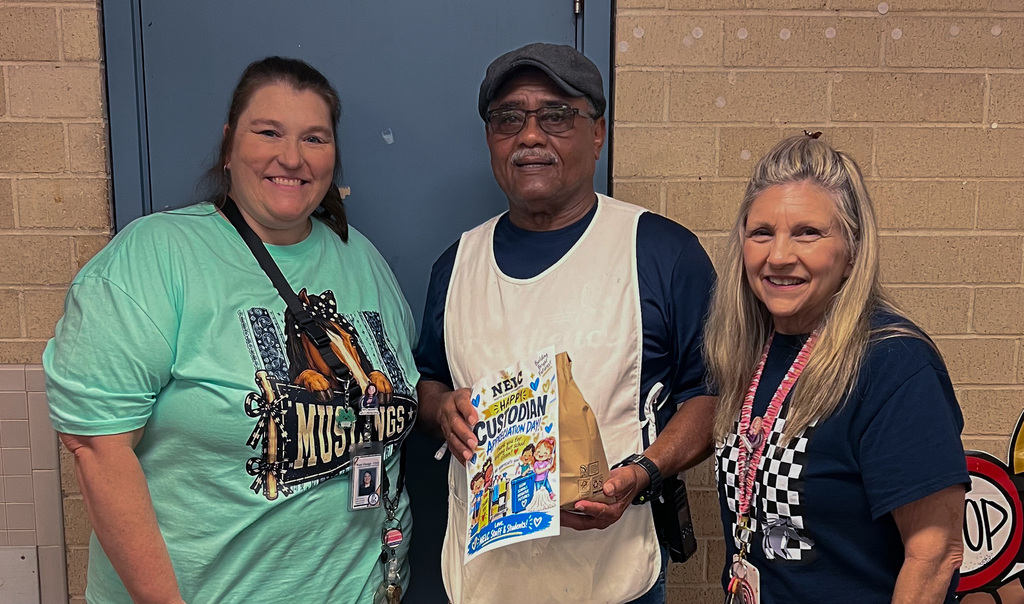 NELC staff surprising custodian with gift