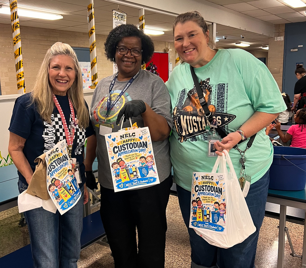 NELC teacher and principal giving custodian a gift bag