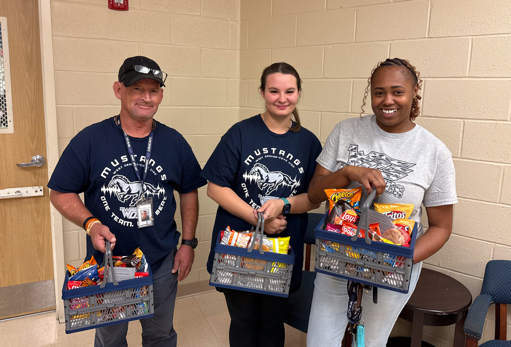 WOSE custodians holding gift baskets