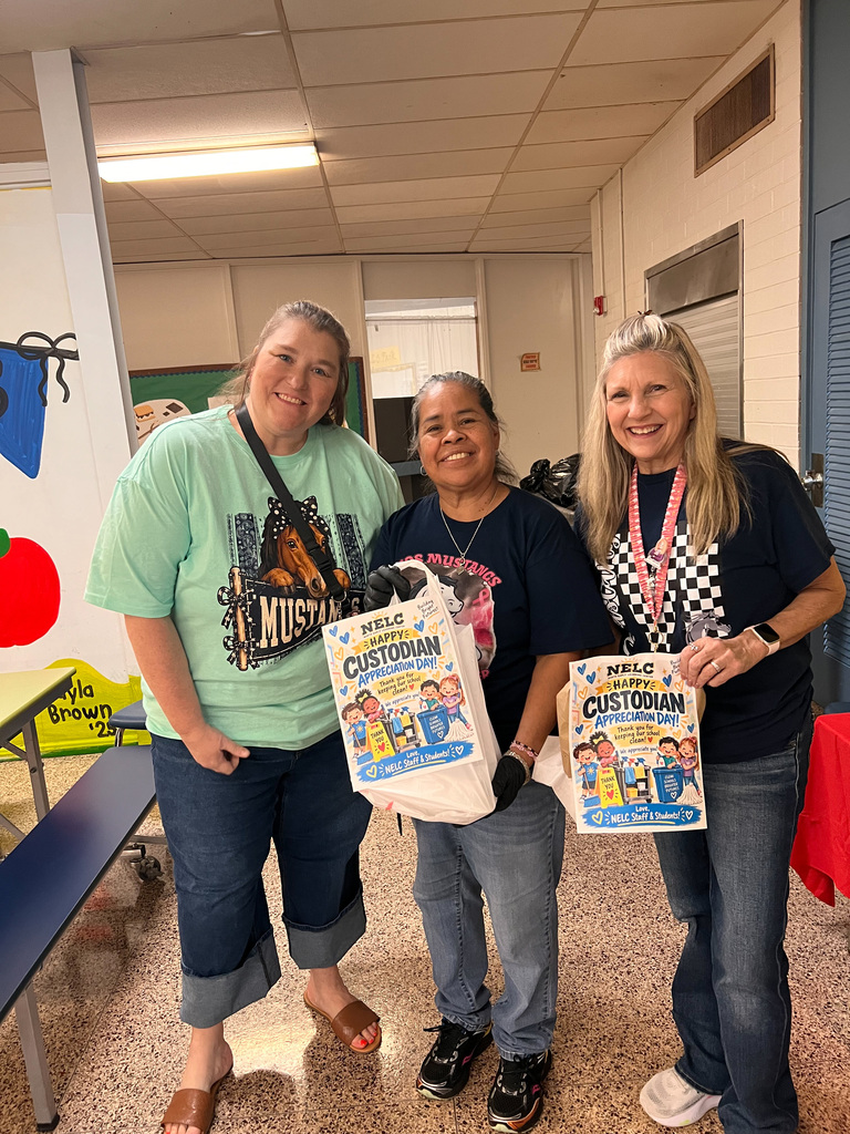 NELC staff present custodian with gift bag