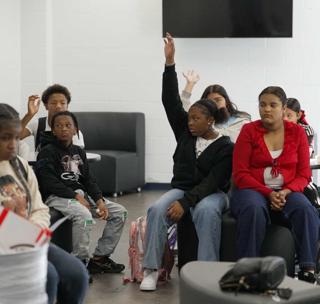 several students raising their hand