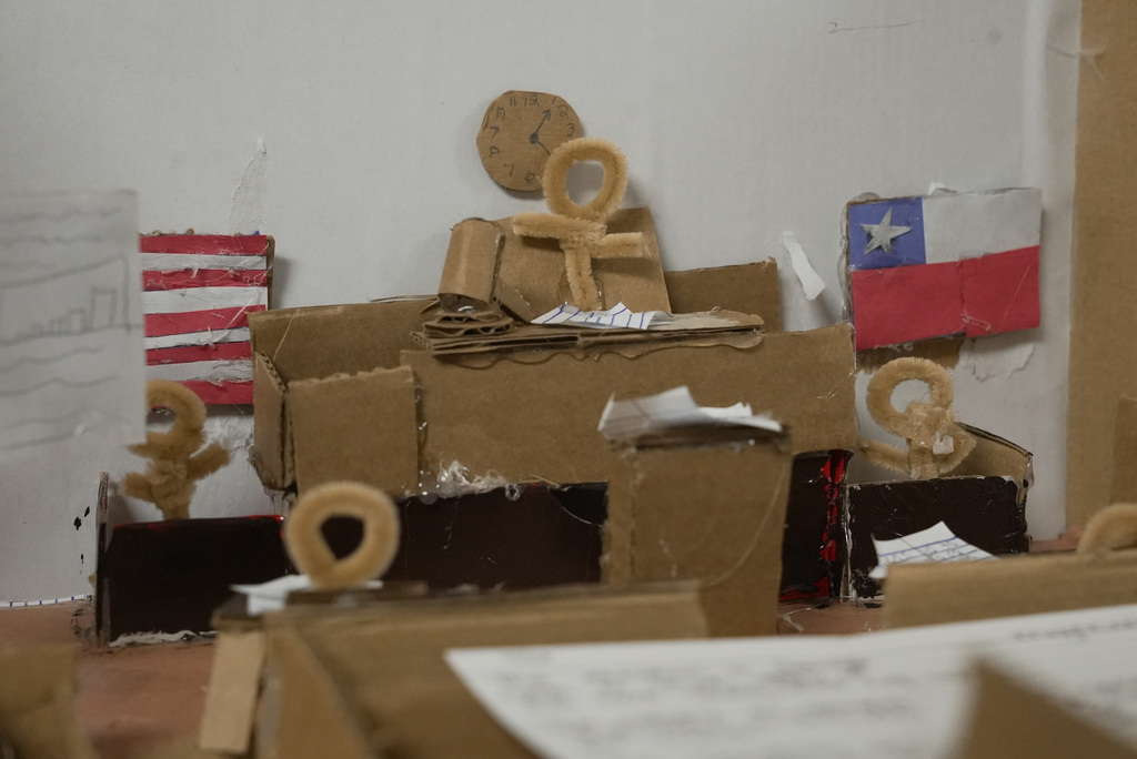 humans made of pipe cleaners sitting in a cardboard courtroom