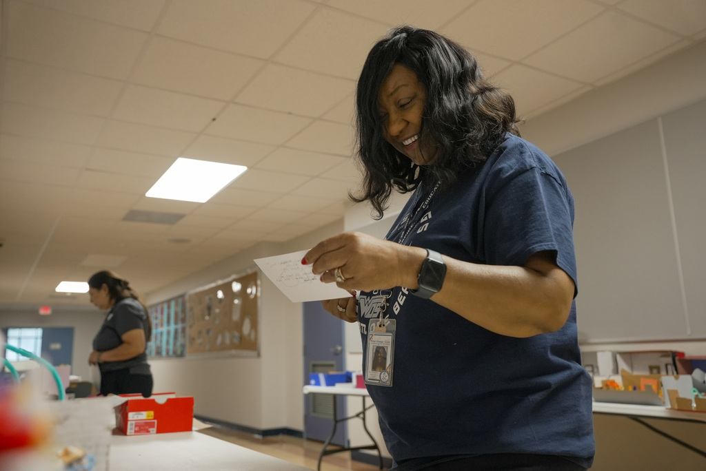 Dr. Washington reads a card for a student project