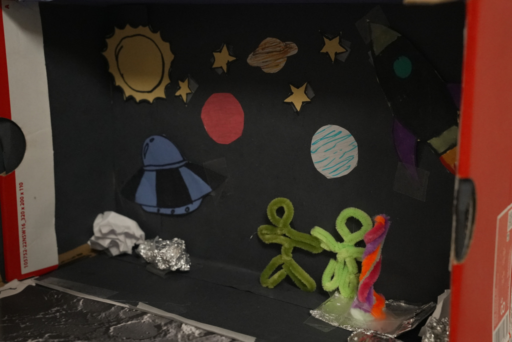 A space scene for an astronaut, with planets and stars in the background, and aliens standing