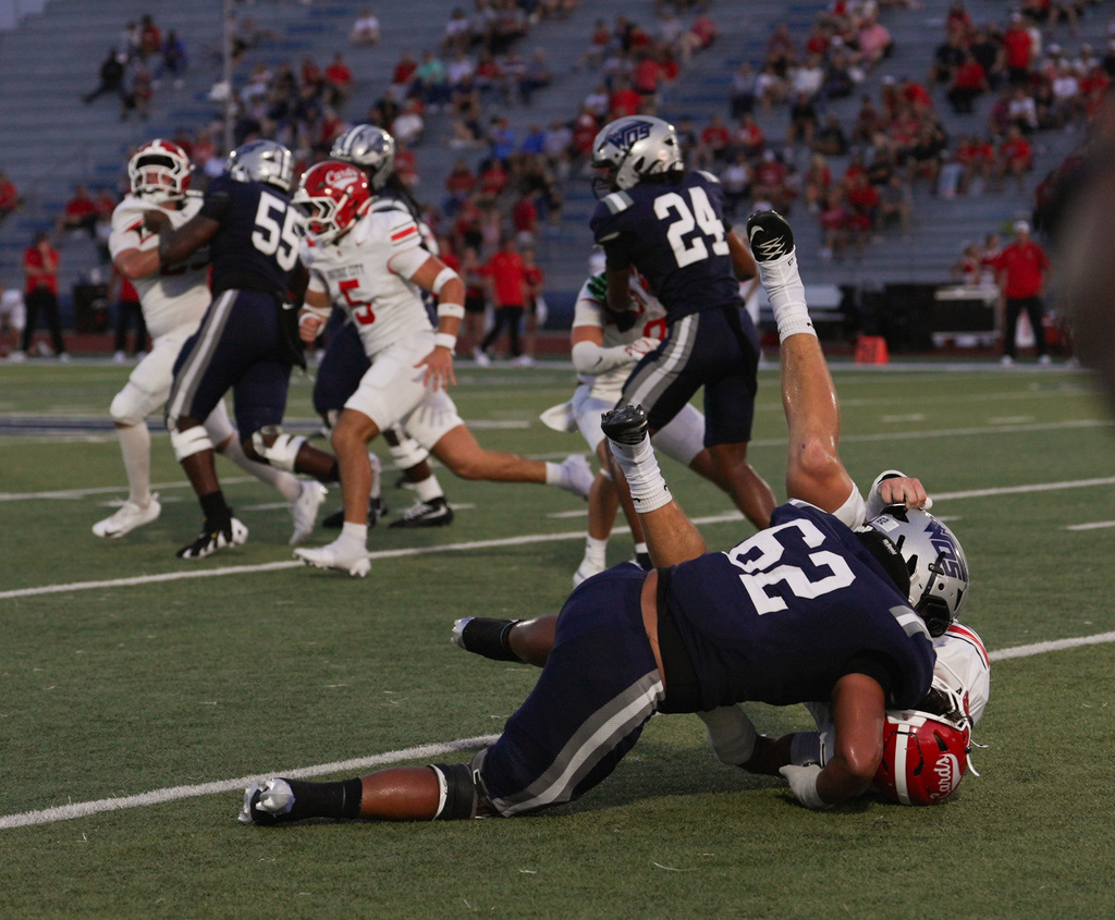 #62 forces an opposing player down while players in the background scramble