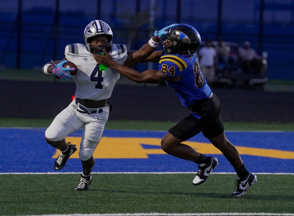 #4 pushes a defender away while holding the ball