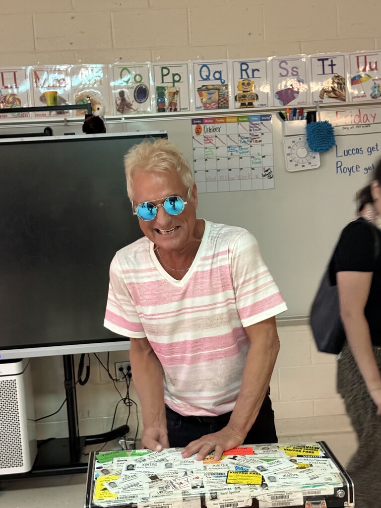 Kevin Spencer smiling while wearing reflective sunglasses