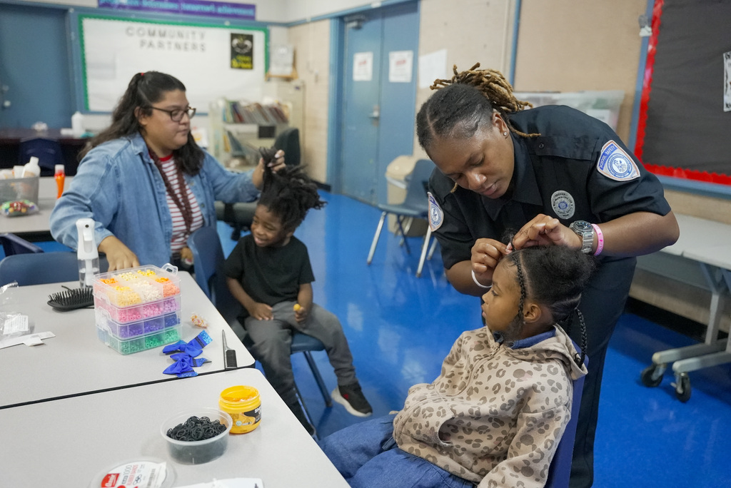 the Family Services working on the hair of a boy and a girl