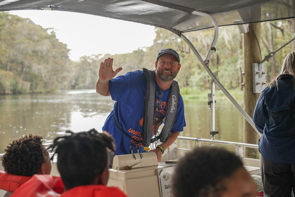 boat captain waving at the camera