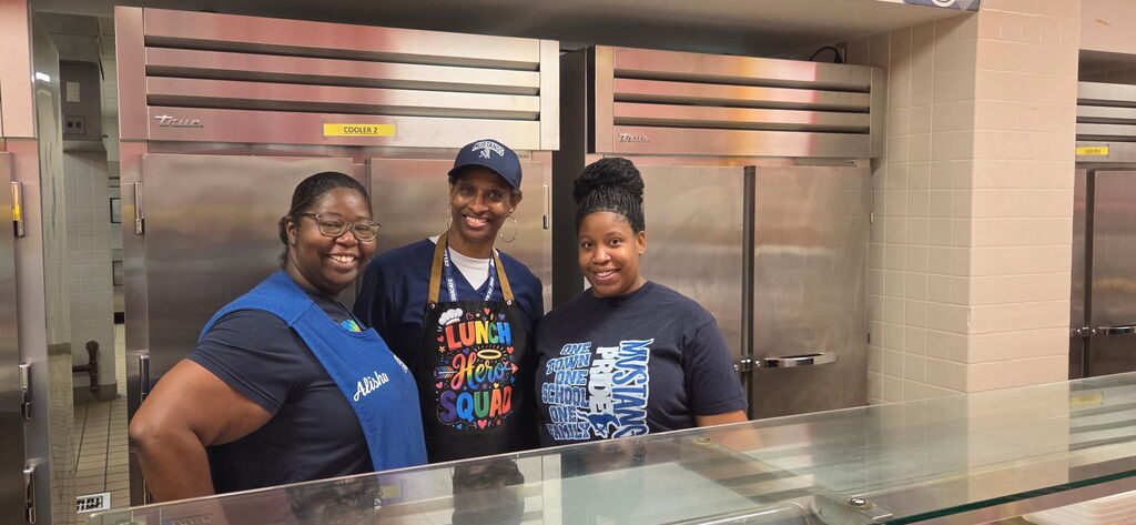 school board trustee Linda Platt-Bryant poses with cafeteria workers