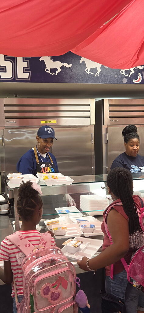 school board trustee helps serve breakfast