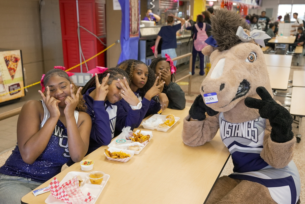 WOSHS Mascot Clutch poses with WOSMS cheerleaders