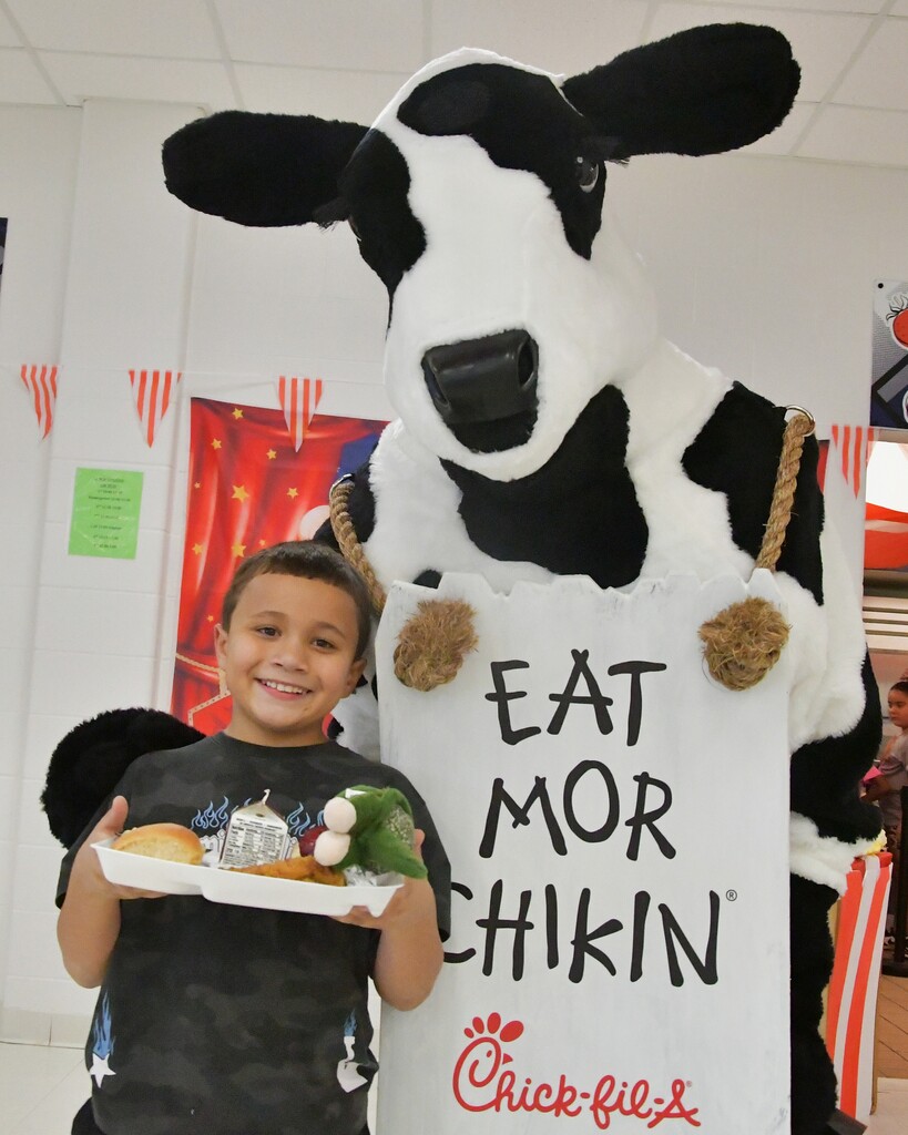 Happy WOSE student with Cow the Chick-Fil-A Mascot