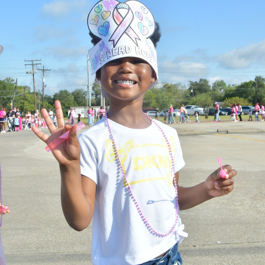 Child walking in Pinkout Parade